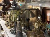 many different types of lamps on a shelf in a store