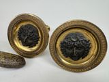 pair of gold plated cufflinks with a head of a man and a woman