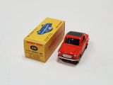 a red toy car next to a yellow box on a white surface