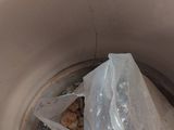a trash can with a bag of rocks inside of it