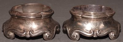 pair of silverplated candlestick holders on a black background