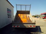 an image of a dump truck parked in front of a building