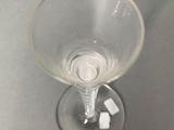 a wine glass with a small amount of sugar cubes in it