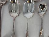 a lot of silver spoons and spoon spoons on a table