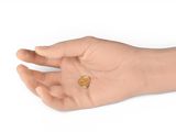 someone is holding a gold heart in their hand on a white background