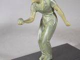 statue of a woman holding a tennis ball on a black base