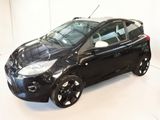 a picture of a small black car parked in a garage