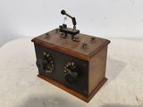 an old fashioned radio sitting on top of a white table