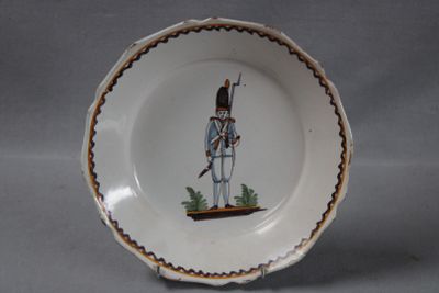 a small plate with a picture of a soldier on it