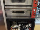 three ovens stacked on top of each other in a kitchen