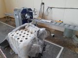 rolls of toilet paper wrapped around a machine in a room