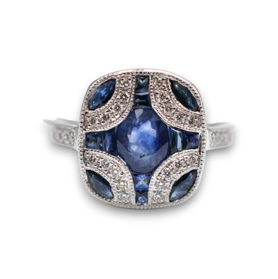 a blue sapphire and diamond ring set in 18k white gold