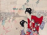 two women dressed in kimono are sitting on a red carpet
