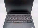 the laptop is open on a white surface with a black keyboard