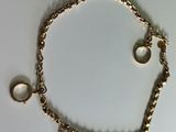 bracelet with two rings and two rings on it on a white surface