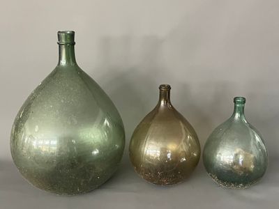three glass vases sitting next to each other on a table
