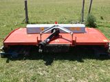 a close up of a lawn mower in a field of grass