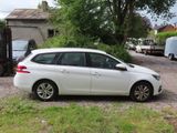 a white car that is parked in front of a house