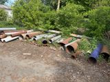 a lot of pipes that are sitting in the dirt