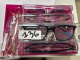 three pairs of glasses sitting in a box on a table