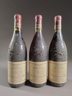 three bottles of wine sitting on top of a table next to each other