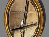 a mirror that is hanging on the wall next to a shelf