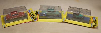 three boxed toy cars sitting on top of each other on a table