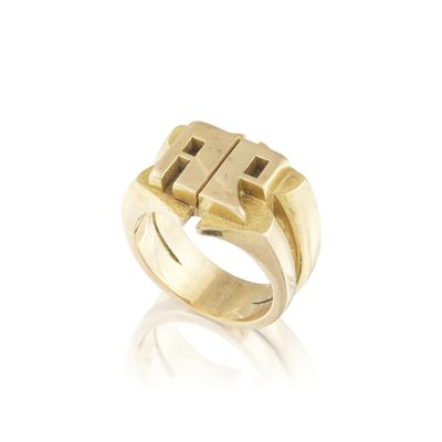 a close up of a gold ring on a white surface