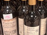 many bottles of wine sitting on a shelf in a store