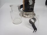 a tea pot and a glass on a white table