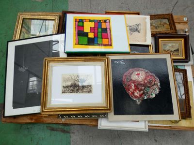 a lot of framed art on a table with pictures