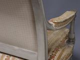 a white couch with a floral upholstered back