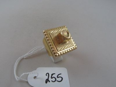 a gold ring with a price tag attached to it