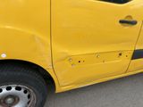 a yellow van with holes on the side of it