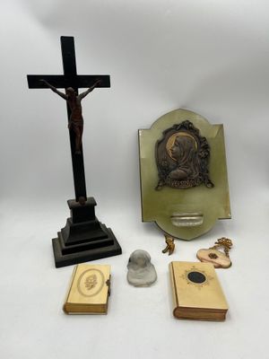 several religious items including a crucif, a cross, a book, and a rosary