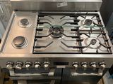 a silver stove top oven sitting on top of a pallet
