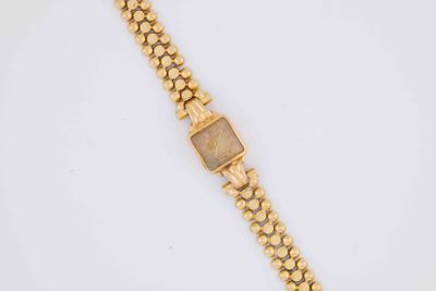 a gold bracelet with a square stone on it