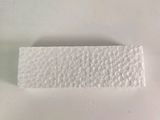 a close up of a piece of white paper on a white surface