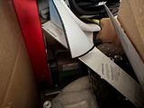a cardboard box with scissors and other items in it