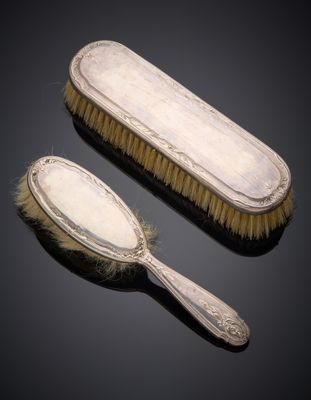 une paire de brosses argentées et une brosse sur fond noir