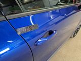 a close up of a car door handle with a sticker on it