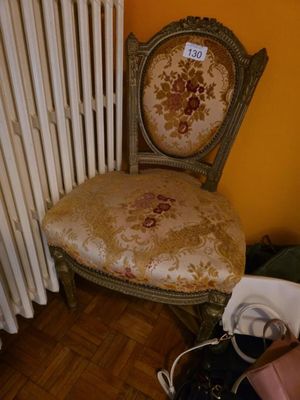 a chair that is next to a radiator in a room
