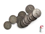 several coins are stacked on top of each other on a white surface
