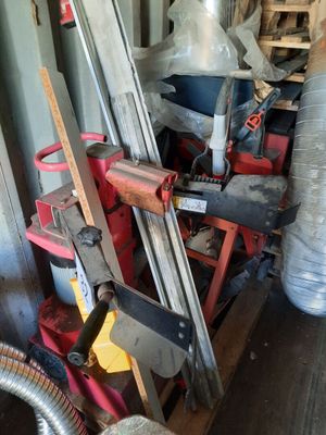 a pile of clutter and tools in a garage
