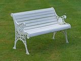 a white bench sitting in the middle of a grassy field