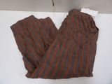 brown and orange striped pants sitting on top of a white table