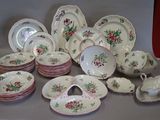 many plates and cups and saucers on the table