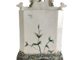 a white vase with flowers and birds on it