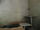 a bed and a table in the corner of a room
