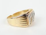a close up of a gold ring with three diamonds on it